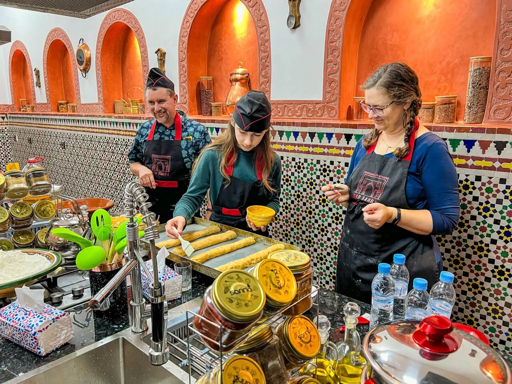 Students taking part in a Moroccan cooking class during an educational tour