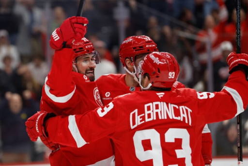 Detroit Red Wings players celebrating on the ice