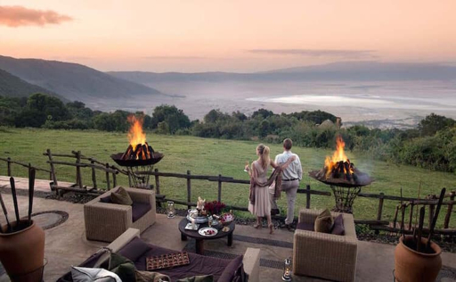 Couple on a safari lodge deck at sunset in Tanzania