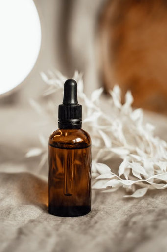 Amber glass dropper bottle on neutral linen; illustrative photography, not an approved product.