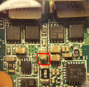 Burnt capacitor on laptop motherboard