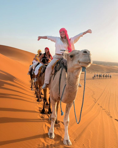 Travellers experiencing the Sahara Desert near Merzouga Morocco