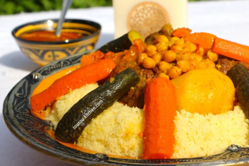Traditional Moroccan couscous in a decorative bowl with vegetables and chickpeas