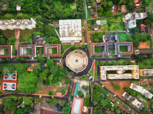 Aerial view of Manipal Institute of Technology (MIT) Student Plaza, with surrounding campus buildings, pathways, green spaces, and sports courts