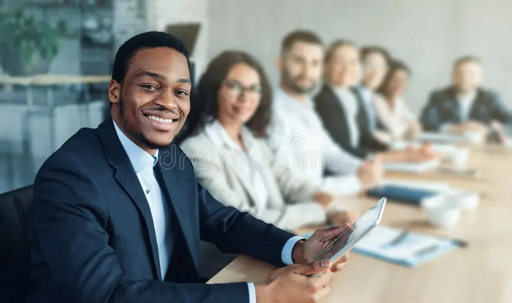 Smiling professional holding a tablet in a team meeting