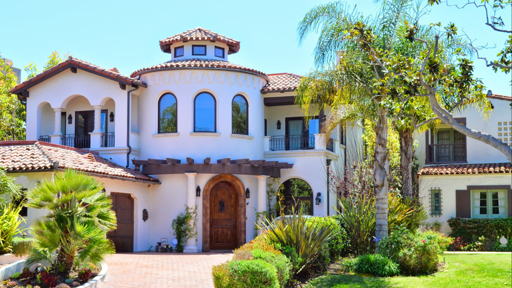Mediterranean-style Santa Barbara home exterior with white stucco and red tile roof