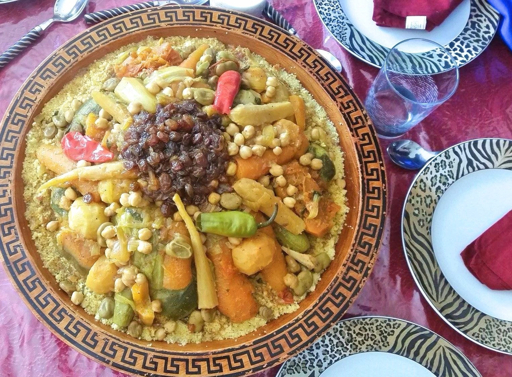 Traditional Moroccan tagine filled with couscous, meat, chickpeas and vegetables