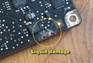 Laptop motherboard with liquid damage and corrosion
