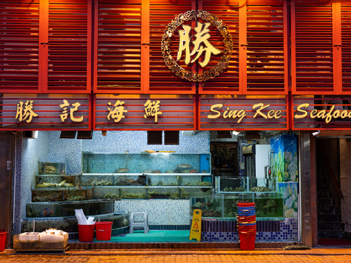 The red illuminated facade of Sing Kee Seafood Restaurant in Sai Kung at night