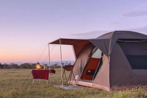 Camping tent at dusk on a budget safari in the Serengeti, Tanzania