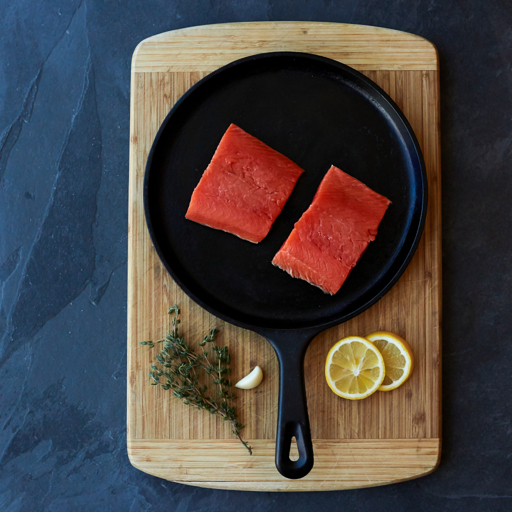 Sockeye salmon portions in a cast iron pan