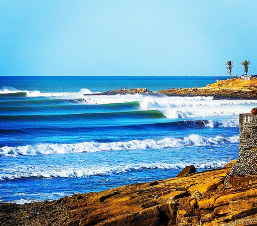 Anchor Point surf break in Taghazout Morocco with Atlantic waves and rocky coast