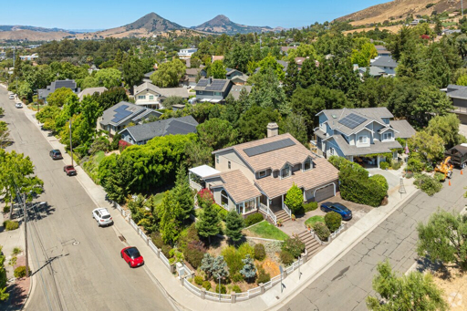 Aerial view of Orcutt neighborhood with single-family homes, tree-lined streets, and hills in the background