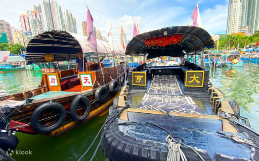 Traditional sampan boats in Aberdeen Harbour, Hong Kong, with skyscrapers in the background