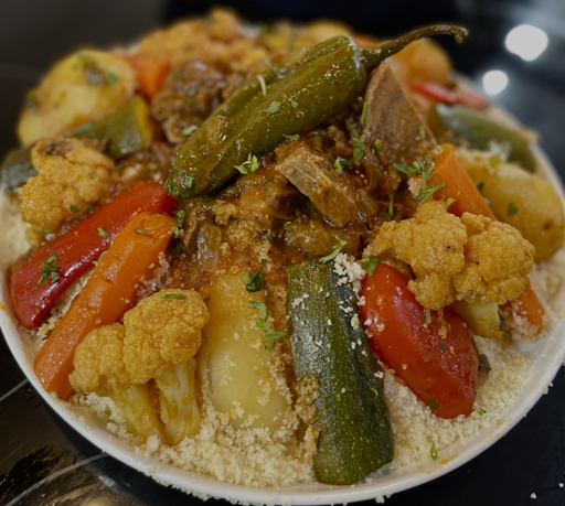 Close-up of Moroccan couscous with meat, cauliflower, carrots, zucchini and peppers