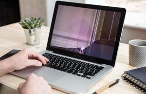 Broken laptop screen with cracks